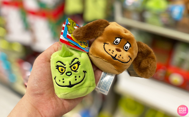 Hand Holding The Grinch Marshmallow Plushies at Hobby Lobby