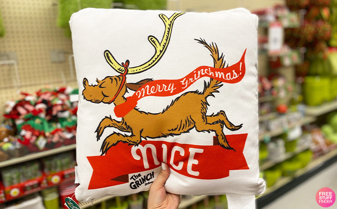 Hand Holding The Grinch Max Christmas Pillow at Hobby Lobby