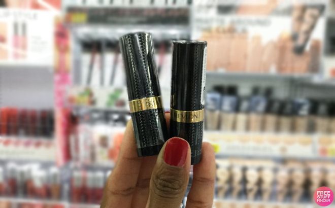 Hand Holding Two Revlon Lipsticks Hand Holding Two Revlon Lipsticks
