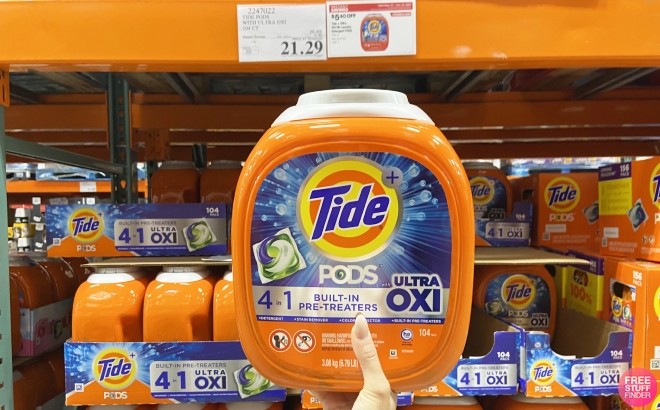 Hand Holding a Container of Tide Ultra Oxi Laundry Detergent Pods