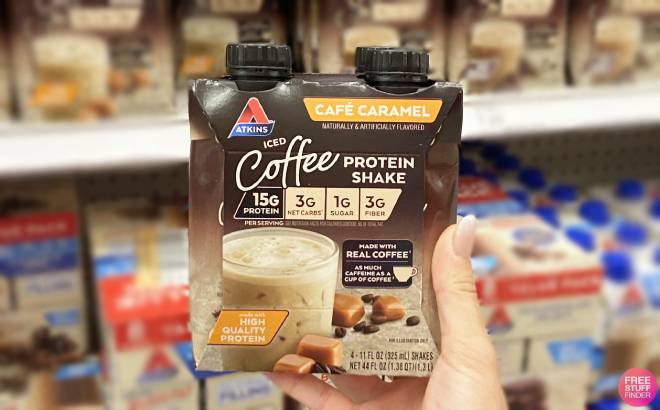 Hand Holding a Pack of Atkins Cafe Caramel Iced Coffee Protein Shak