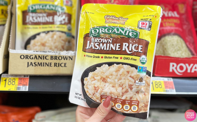 Hand Holding a Pouch of Golden Star Organic Jasmine Brown Rice