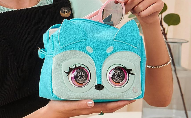Hand Holding a Purse Pets Fierce Fox Interactive Toy