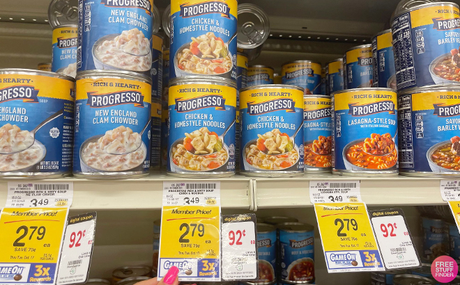 Hand Holding a Tag with Progresso Variety of Soups on the Shelf at Vons