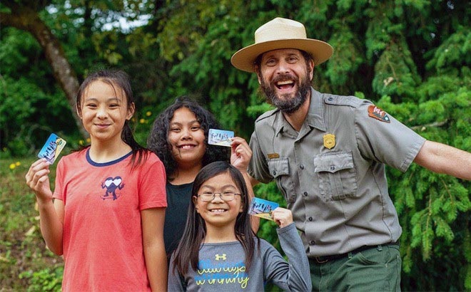Happy kids showing their National Park pass