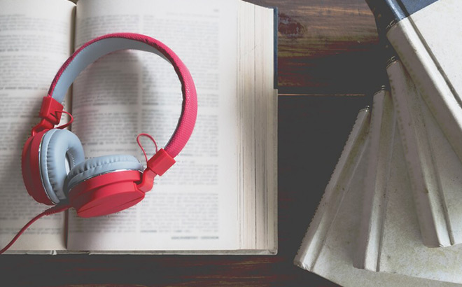Headphones on top of an Open Book