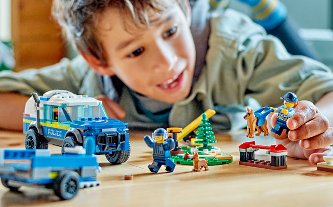 Kid Playing with a LEGO City Mobile Police Dog Training Building Set