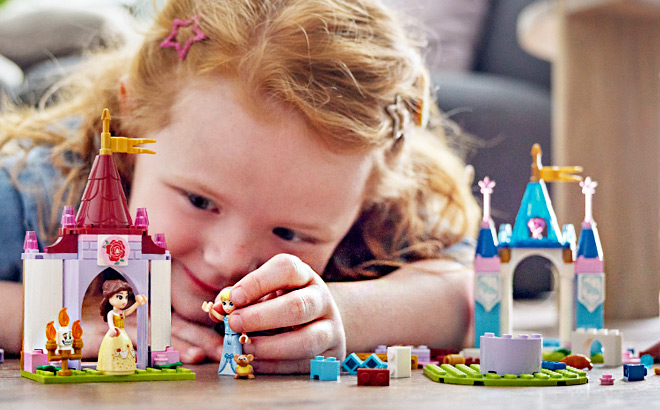 Kid Playing with a LEGO Disney Princess Toy Castle Building Set