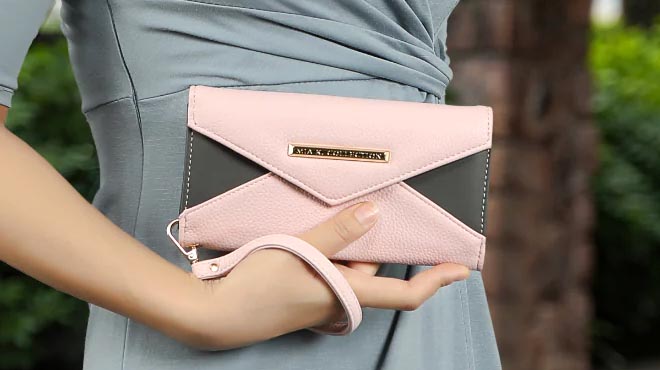 Lady holding MKF Kearny Vegan Leather Womens Wallet Bag Pink