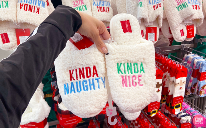 Person Holding Wondershop Kinda Naughty Kinda Nice Christmas Slippers in Target