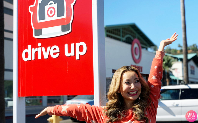 Tina Standing in Front of the Target Drive Up Sign Outside of the Store with Open Arms Smiling