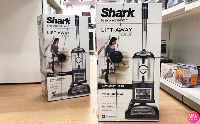 Two Shark Navigator Lift-Away Deluxe Upright Vacuums on the Floor at a Kohl's Store
