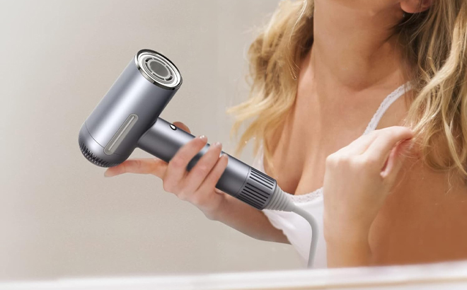 Woman Using Professional Ionic Blow Dryer with 110 000 RPM Brushless Motor in Gray
