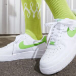Woman Wearing Nike Air Force 1 07 Shoes in Action Green Color