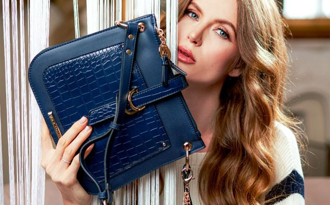 Woman is Holding MKF Kiltienne Crossbody Bag in Navy Color
