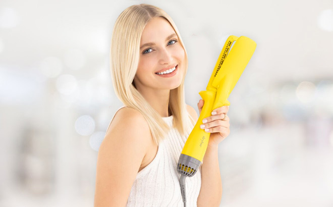 Woman is Holding a Blow Drying Flat Iron from Drybar