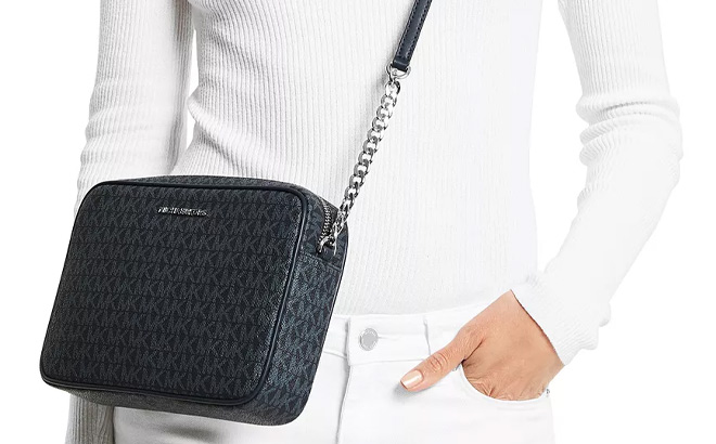 Woman is Wearing Michael Kors Logo Jet Set East West Crossbody in Admiral Blue and Pale Blue Color