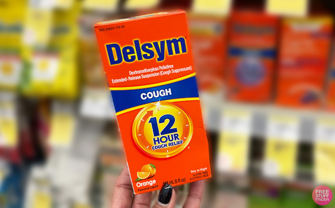a Hand Holding Delsym Cough Product