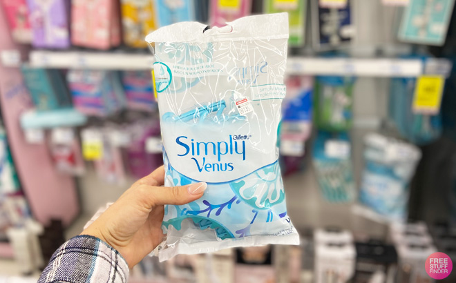 a Hand Holding Gilette Venus Razor Pack at CVS