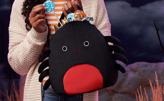 a Person Carrying a Squishmallows 10 Inch Bella Spider Plush Treat Pail
