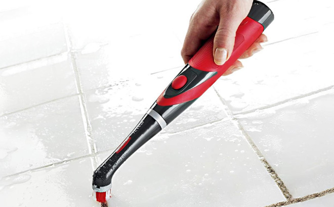 a Person Using Rubbermaid Power Scrubber to Clean the Grouts