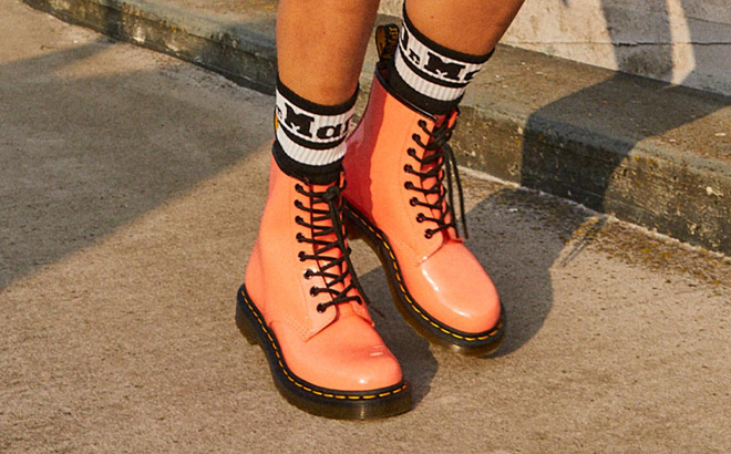 a Woman Wearing Dr Martens Womens 1460 Boots in Coral Color