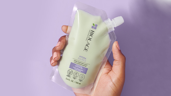 an Image of a Hand Holding a Biolage Hydra Source Deep Treatment Pack