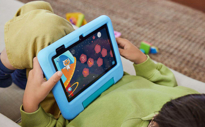 A Child Using an Amazon Fire 7 Kids Edition Tablet in Blue