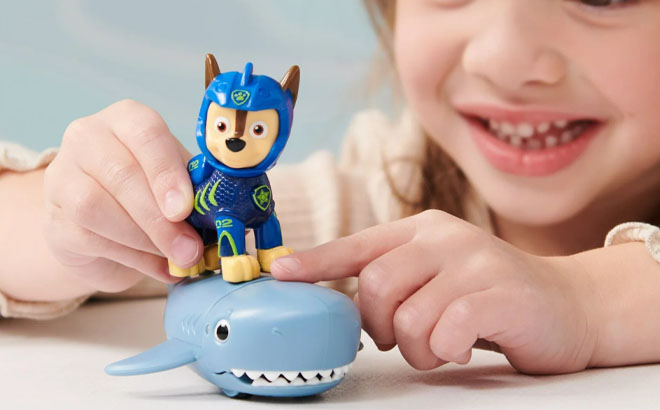 A Girl Playing a PAW Patrol Aqua Pups Chase and Shark Action Figures