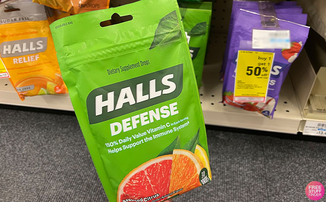 A Hand Holding Halls Cough Drops A Hand Holding Halls Cough Drops