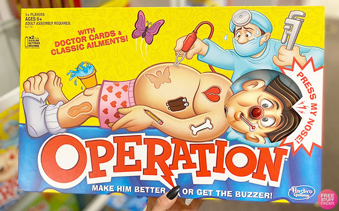 A Hand Holding a Hasbro Classic Family Favorite Operation Board Game