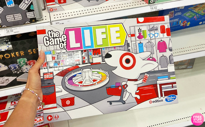 A Hand Holding a Hasbro Gaming Game of Life Target Edition