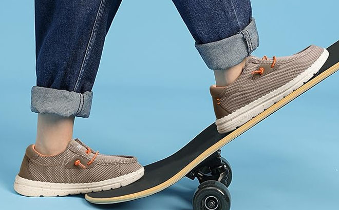 A Kid Wearing a Bruno Marc Kids Slip On Casual Loafer While Stepping on a Skateboard