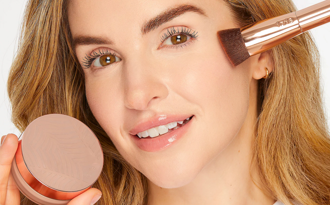 A Person Using Tarte Foundation and Brush Set A Person Using Tarte Foundation and Brush Set