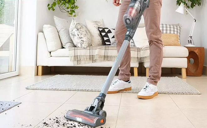 A Person Using the BlackDecker Cordless Stick Vacuum to Clean the Floor at a Home