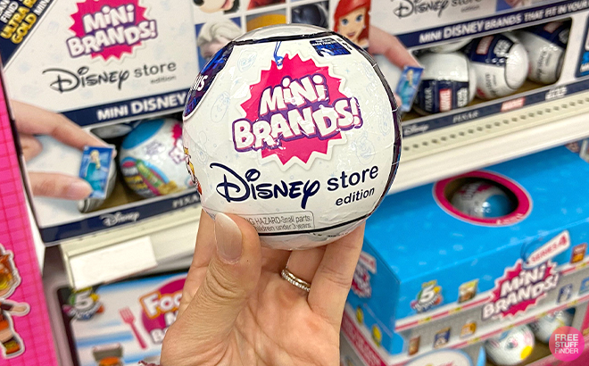 Hand Holding 5 Surprise Disney Mini Brands