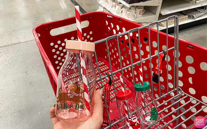 Hand Holding Christmas Copper Feliz Navi Dog Tumbler with Straw in Target Store