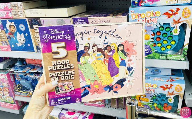 Hand Holding Disney Princess 5 Pack of Wood Jigsaw Puzzle in Storage Box