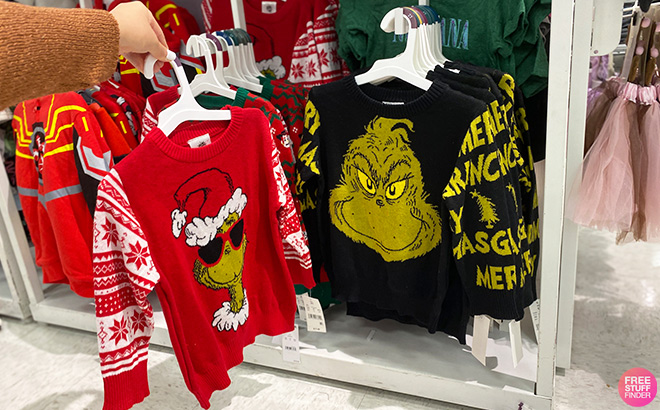 Hand Holding Grinch Sweaters at Target