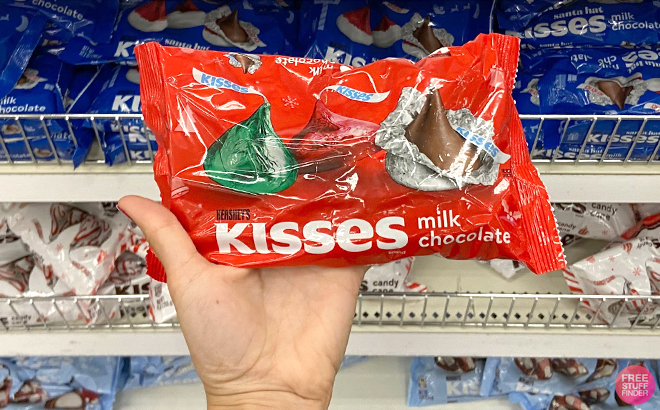 Hand Holding Hershey's Kisses Red, Green & Silver Foils Bag