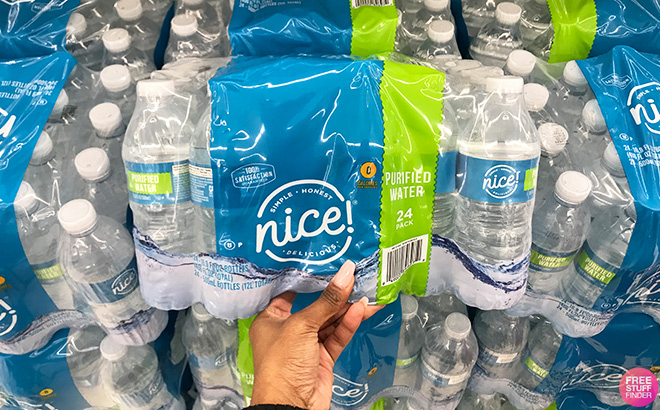 Hand Holding Nice Water 24 Pack in a Store Aisle