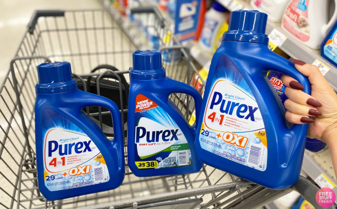 Hand Holding Purex Liquid Laundry Detergent with Two More Detergents in Cart