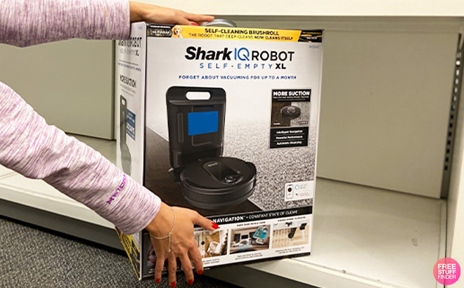 Hand Holding Shark IQ Robot Self Empty XL Vacuum