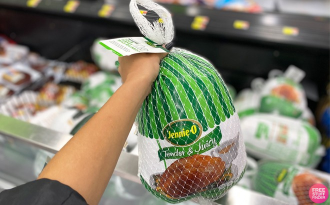 Hand Holding a Jennie O Tender Juicy Turkey at Walmart