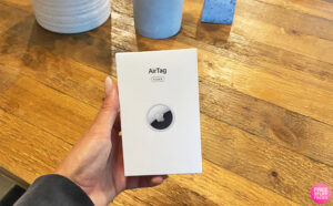 Hand Holding an Apple AirTag 4 Pack