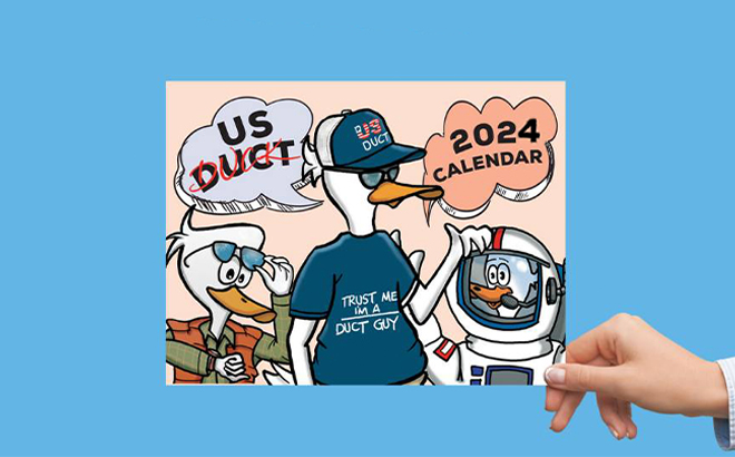 Hand Holding the 2024 US Duct Duck Calendar on a Blue Background