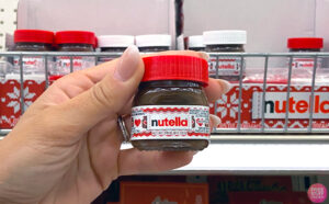 Hand holding one Nutella Holiday Mini Chocolate Hazelnut Spread