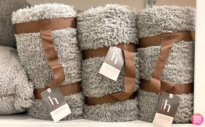 Home Expressions Fleece Throws on a Shelf Home Expressions Fleece Throws on a Shelf