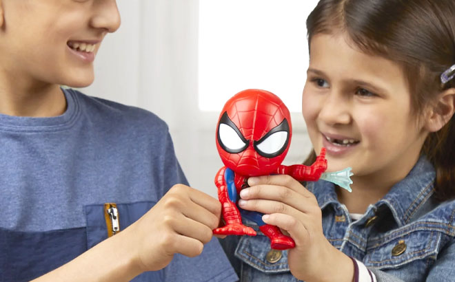 Kids Playing a Bop It Marvel Spider Man Edition Electronic Game