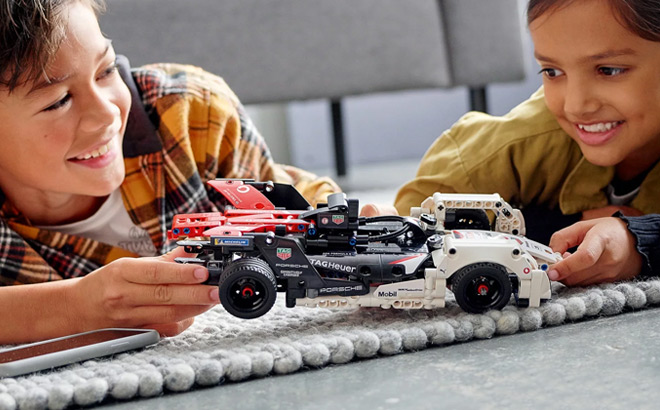 Kids Playing with LEGO Technic Formula E Porsche